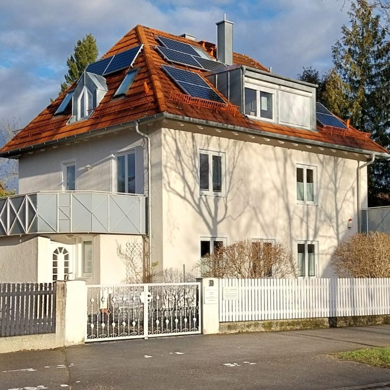 Großes Haus mit rotem Dach und Sonnenkollektoren